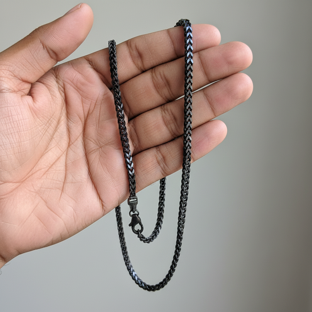 Customer POV - hand holding black wheat chain